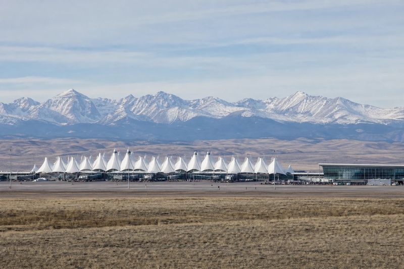The white peaked roof of the Jeppesen Terminal at Denver International Airport under an open sky