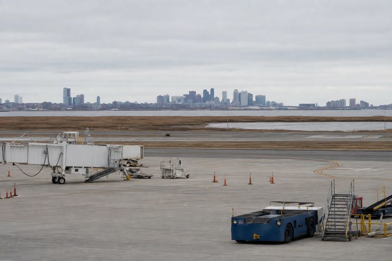 Aircraft at a terminal at Newark Liberty International Airport with the New York skyline in the distance