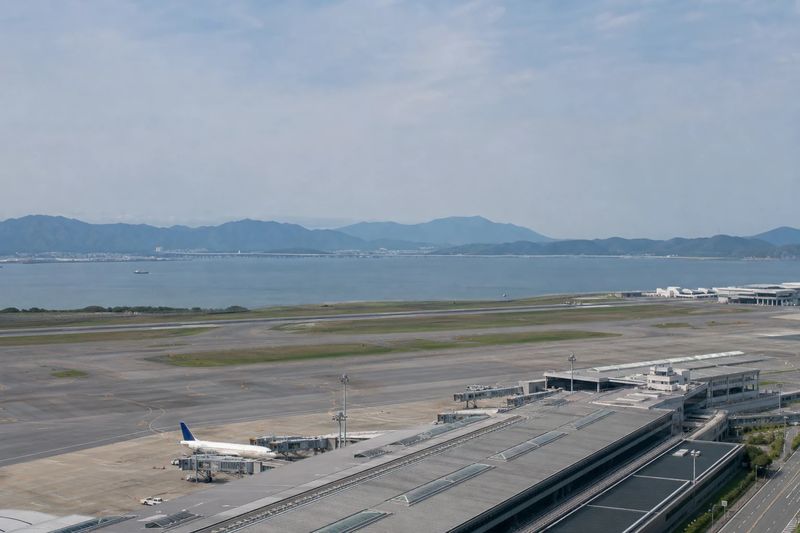 Aircraft at a San Francisco International Airport terminal with San Francisco Bay behind